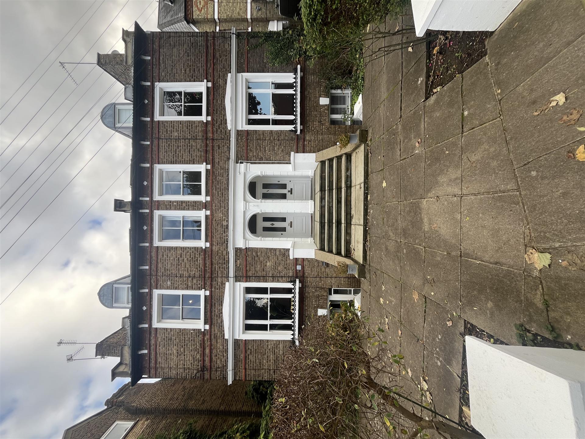 Brick terrace house with white window frames and door surround, Essex